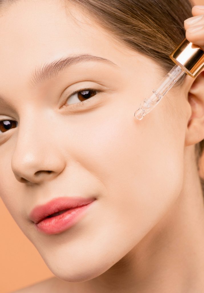 a model applying vrh vitamin c serum on face